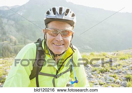 Caucasian man smiling on rocky trail View Large Photo Image Stock Photograph - Caucasian man smiling on rocky trail. Fotosearch