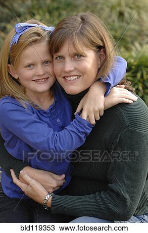 Stock Image - Caucasian mother and daughter smiling outdoors. Fotosearch