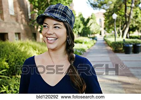 Stock Image - Caucasian student smiling on campus. Fotosearch