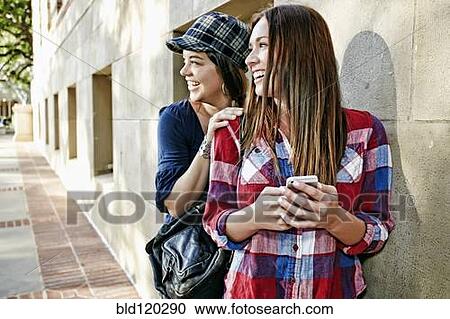Stock Image - Caucasian students smiling on campus. Fotosearch