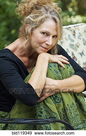 Stock Photo - Caucasian woman sitting outdoors. Fotosearch
