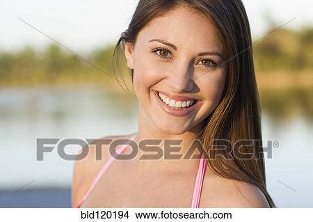 Picture - Caucasian woman smiling outdoors. Fotosearch