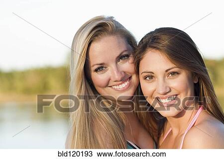 Stock Image - Caucasian women smiling outdoors. Fotosearch