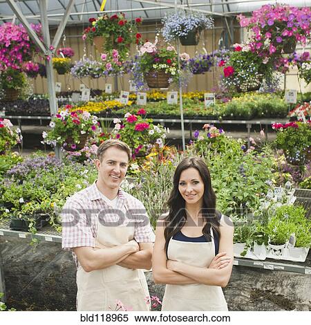 Stock Photography - Caucasian workers smiling in plant nursery. Fotosearch