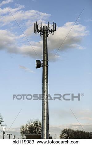 Stock Image - Cell tower overlooking street. Fotosearch