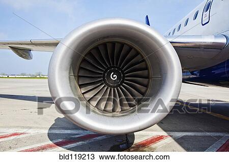 Stock Image - Close up of airplane jet engine on runway. Fotosearch
