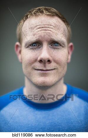 Stock Photograph - Close up of Caucasian man making a face. Fotosearch