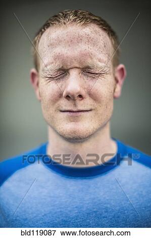 Stock Photo - Close up of Caucasian man squinting. Fotosearch
