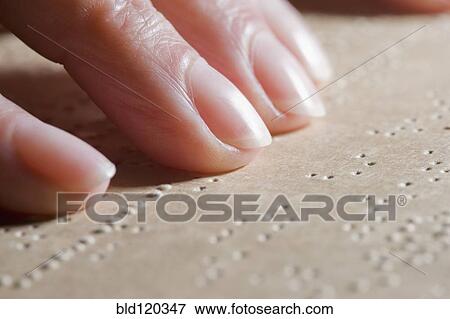 Stock Photo - Close up of Hispanic woman reading Braille. Fotosearch