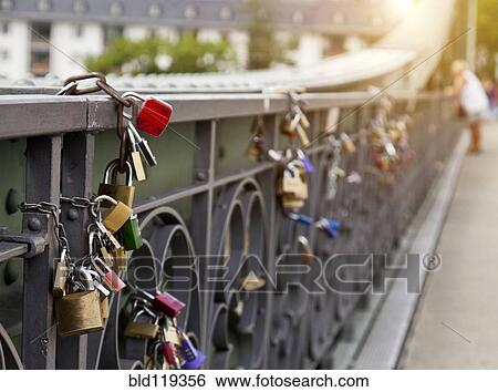 Close up of locks strung on urban bridge View Large Photo Image Stock Photograph - Close up of locks strung on urban bridge. Fotosearch
