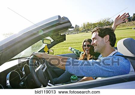 Couple driving in convertible View Large Photo Image Stock Image - Couple driving in convertible. Fotosearch