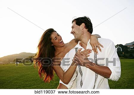 Stock Photo - Couple hugging in park. Fotosearch