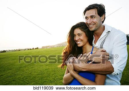Stock Photo - Couple hugging in park. Fotosearch