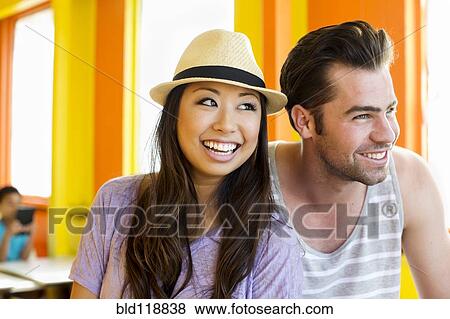 Couple relaxing together in restaurant View Large Photo Image Stock Photo - Couple relaxing together in restaurant. Fotosearch