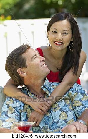 Stock Photograph - Couple relaxing together outdoors. Fotosearch