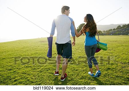 Picture - Couple walking together in park. Fotosearch