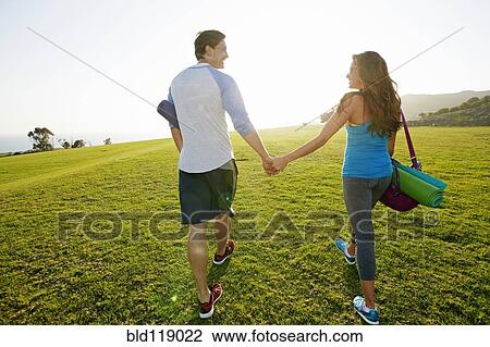 Couple walking together in park View Large Photo Image Stock Image - Couple walking together in park. Fotosearch