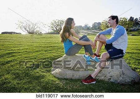 Stock Photo - Couple wearing workout gear in park. Fotosearch