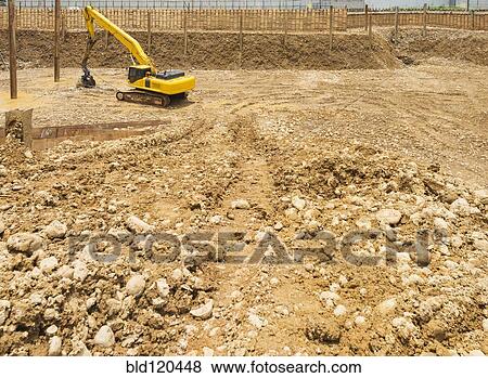 Stock Photo - Digger working on construction site. Fotosearch