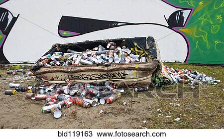 Dumpster filled with spray paint cans on city street with graffiti View Large Photo Image Stock Image - Dumpster filled with spray paint cans on city street with graffiti. Fotosearch