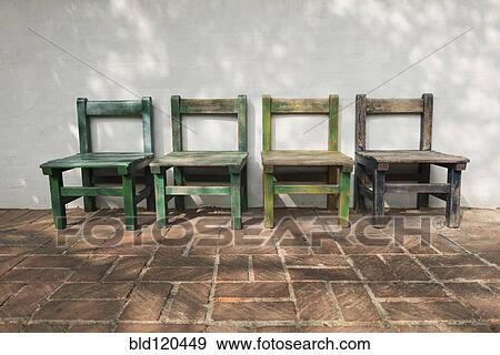 Stock Photo - Empty wooden chairs outdoors. Fotosearch