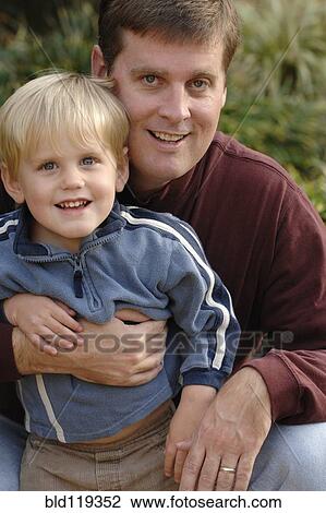 Father and son smiling outdoors View Large Photo Image Stock Image - Father and son smiling outdoors. Fotosearch