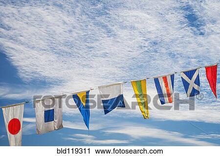 Stock Image - Flags flying against blue sky. Fotosearch