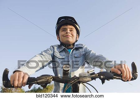 Picture - Hispanic boy riding bicycle. Fotosearch