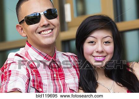 Stock Photography - Hispanic couple smiling outdoors. Fotosearch