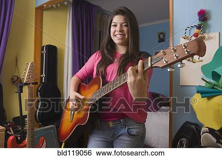Stock Photograph - Hispanic girl playing guitar. Fotosearch