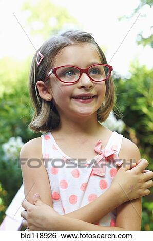 Stock Photograph - Hispanic girl smiling outdoors. Fotosearch