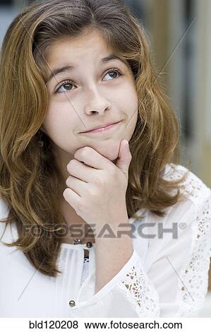 Stock Photo - Hispanic girl thinking. Fotosearch