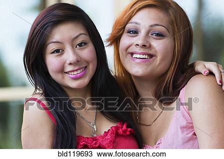 Stock Image - Hispanic girls smiling outdoors. Fotosearch