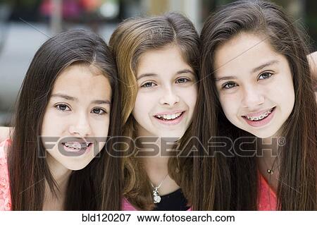 Stock Photo - Hispanic girls smiling together. Fotosearch