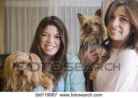 Hispanic mother and daughter holding dogs View Large Photo Image Stock Photo - Hispanic mother and daughter holding dogs. Fotosearch