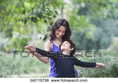 Stock Photo - Hispanic mother and son playing outdoors. Fotosearch