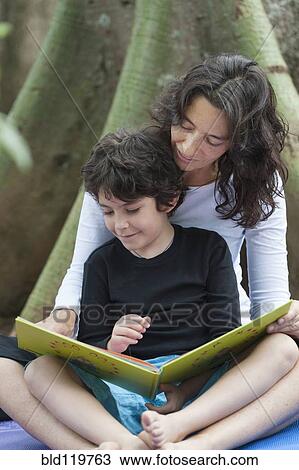 Hispanic mother and son reading outdoors View Large Photo Image Stock Image - Hispanic mother and son reading outdoors. Fotosearch