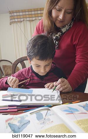 Hispanic mother helping son with homework View Large Photo Image Stock Photo - Hispanic mother helping son with homework. Fotosearch