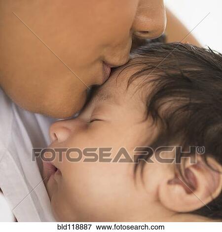 Stock Photo - Hispanic mother kissing infant son. Fotosearch