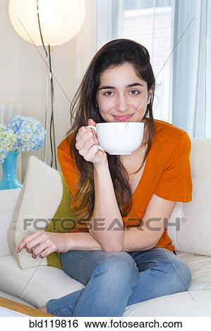 Hispanic woman enjoying cup of coffee View Large Photo Image Stock Photograph - Hispanic woman enjoying cup of coffee. Fotosearch