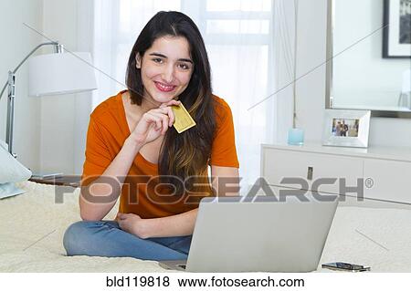 Hispanic woman shopping online View Large Photo Image Stock Photo - Hispanic woman shopping online. Fotosearch