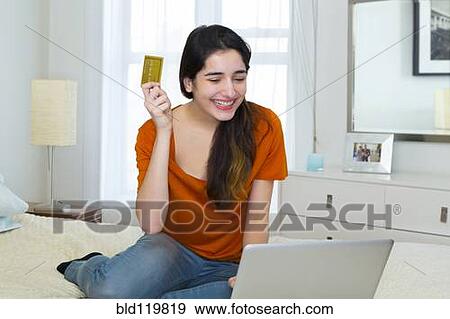 Hispanic woman shopping online View Large Photo Image Stock Photo - Hispanic woman shopping online. Fotosearch
