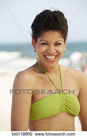 Hispanic woman smiling on beach View Large Photo Image Stock Image - Hispanic woman smiling on beach. Fotosearch