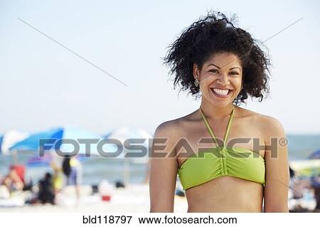 Hispanic woman smiling on beach View Large Photo Image Stock Photo - Hispanic woman smiling on beach. Fotosearch