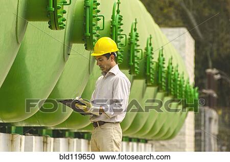 Hispanic worker checking tanks View Large Photo Image Stock Image - Hispanic worker checking tanks. Fotosearch