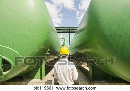 Hispanic worker checking tanks View Large Photo Image Stock Image - Hispanic worker checking tanks. Fotosearch