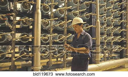 Hispanic worker with cell phone in warehouse View Large Photo Image Stock Image - Hispanic worker with cell phone in warehouse. Fotosearch