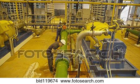 Hispanic workers examining pipes in factory View Large Photo Image Picture - Hispanic workers examining pipes in factory. Fotosearch