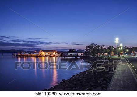 Illuminated buildings on water at dawn View Large Photo Image Stock Image - Illuminated buildings on water at dawn. Fotosearch