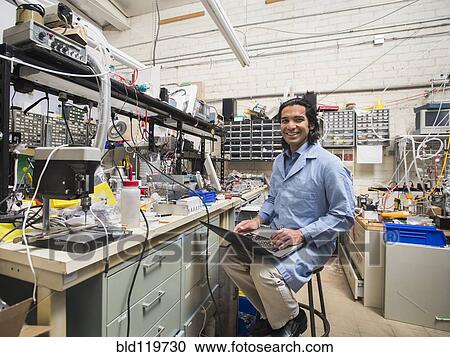 Stock Image - Indian scientist working in laboratory. Fotosearch